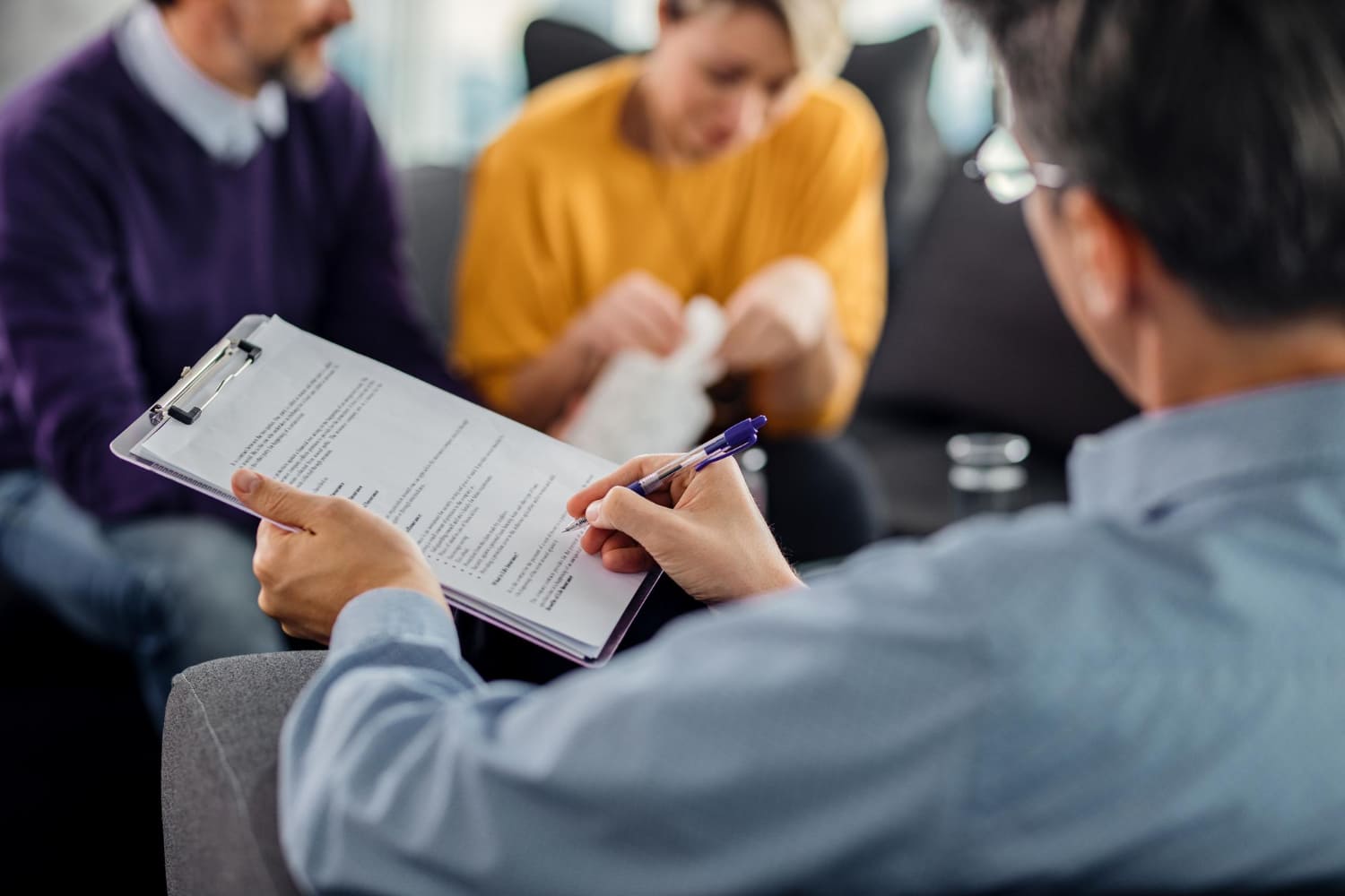 Adjuster reviewing a claim with a family